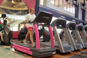 Rachael Estess walks on the pink CYBEX treadmill at Gainesville Health and Fitness Center.